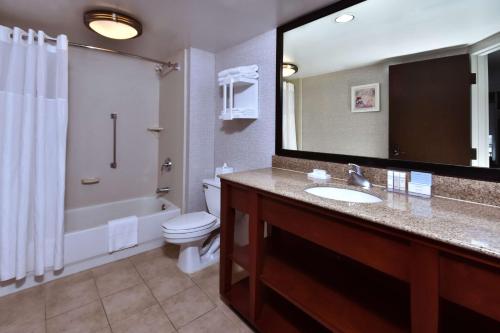 a bathroom with a sink and a toilet and a mirror at Hampton Inn Princeton in Princeton