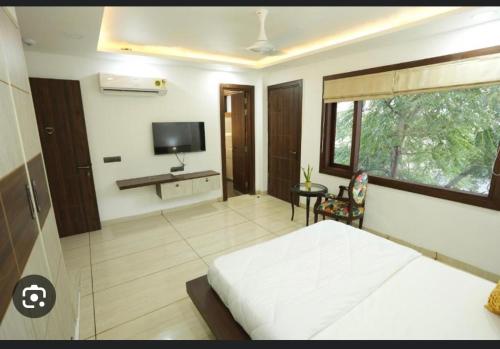 a bedroom with a bed and a television in it at Cyber Vista in Gurgaon