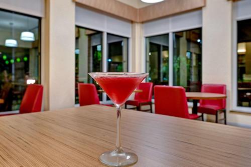 a drink in a martini glass sitting on a table at Hilton Garden Inn San Bernardino in San Bernardino