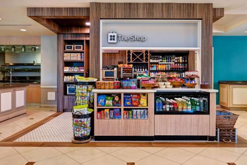 a store with a counter with food and drinks at Hilton Garden Inn San Bernardino in San Bernardino