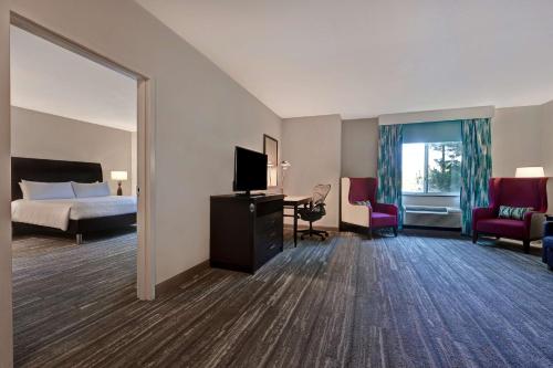 a hotel room with a bed and a television at Hilton Garden Inn San Bernardino in San Bernardino