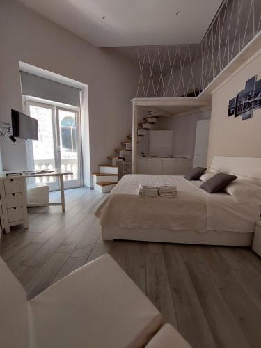 a large bedroom with a large bed and a staircase at Fradalisa Delizioso monolocale a Vico Equense in Vico Equense
