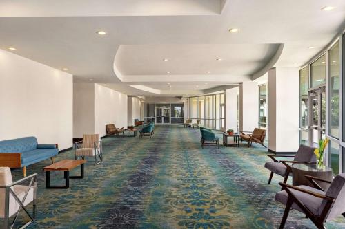 an empty waiting room with chairs and tables at Hilton Garden Inn South Padre Island Beachfront in South Padre Island