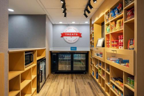 a pharmacy aisle with aethines sign on the wall at Hampton Inn & Suites Alpharetta Roswell in Alpharetta
