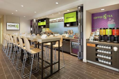 a restaurant with a table and chairs in a store at Home2 Suites by Hilton Durham Chapel Hill in Durham
