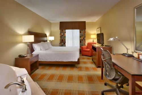 a hotel room with a bed and a desk at Hilton Garden Inn Clarksville in Clarksville