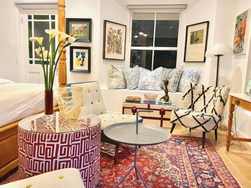 a living room with a bed and a table and chairs at 1 Royal Street Guesthouse in Riebeek-Kasteel