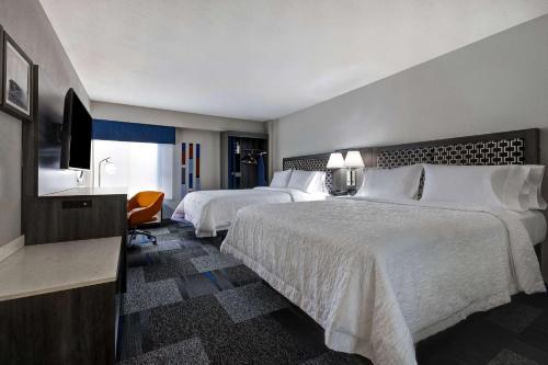 a hotel room with two beds and a television at Hampton Inn San Antonio Downtown in San Antonio