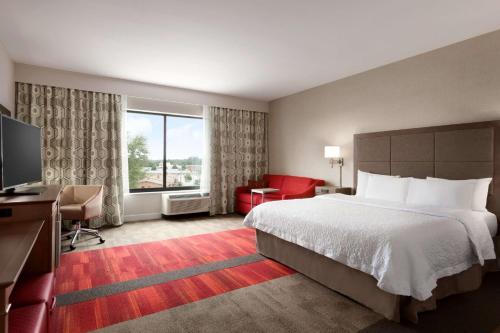 a hotel room with a bed and a large window at Hampton Inn By Hilton North Olmsted Cleveland Airport in North Olmsted
