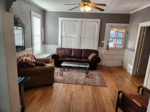 a living room with a couch and a table at Southern Comfort in Tallahassee