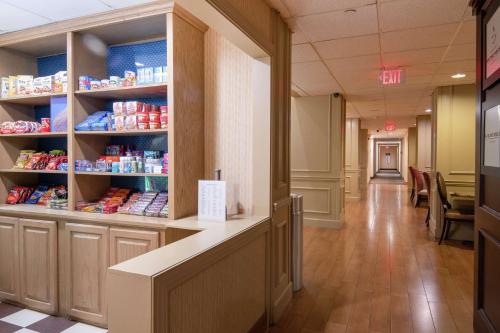a hallway of a store with shelves of food at Hampton Inn & Suites Williamsburg-Richmond Road in Williamsburg