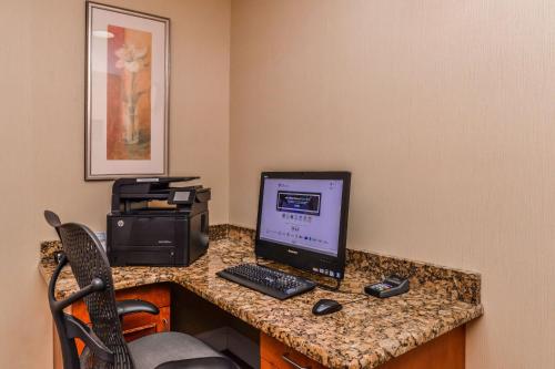 a desk with a computer monitor and a printer at Hilton Garden Inn Detroit Southfield in Southfield