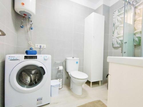 a bathroom with a washing machine and a toilet at Studio with wonderful ocean view and free WiFi, in Icod de los Vinos in Icod de los Vinos