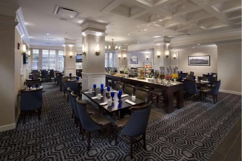 a restaurant with tables and chairs in a room at The Seelbach Hilton Louisville in Louisville
