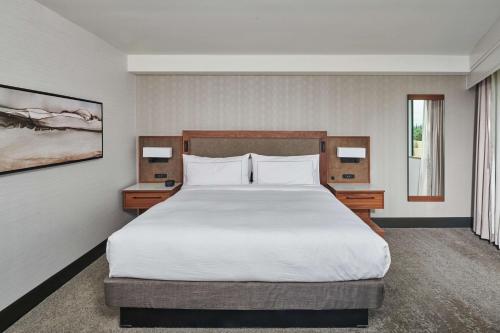 a bedroom with a large bed and two night stands at Doubletree By Hilton Fullerton in Fullerton