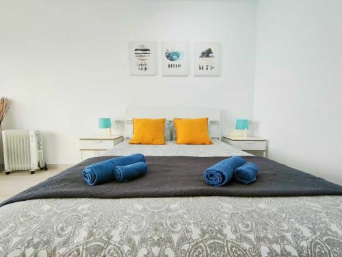 a large bed with blue pillows on top of it at Studio with wonderful ocean view and free WiFi, in Icod de los Vinos in Icod de los Vinos