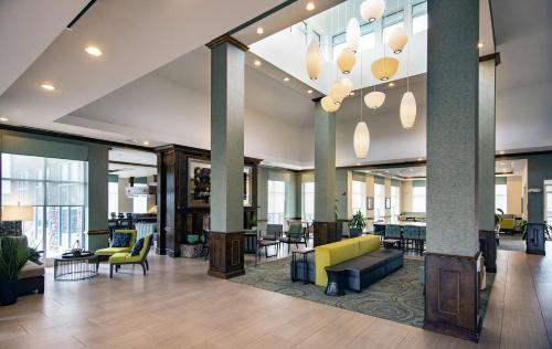 a lobby with a couch and chairs and tables at Hilton Garden Inn Valdosta in Valdosta