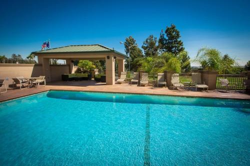 a large swimming pool with a gazebo at Hilton Garden Inn Montebello / Los Angeles in Montebello