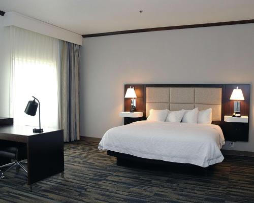 a hotel room with a large bed and a desk at Hampton Inn and Suites Stephenville in Stephenville