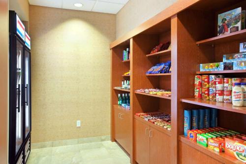a store aisle with shelves of food and drinks at Homewood Suites Saint Cloud in Saint Cloud