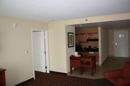 a living room with a kitchen and a dining room at Homewood Suites Saint Cloud in Saint Cloud