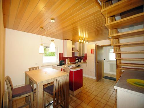 a kitchen with a table and chairs in a room at Birkenhof in Taching am See