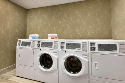 two washing and drying machines in a laundry room at Hilton Garden Inn Statesville in Statesville