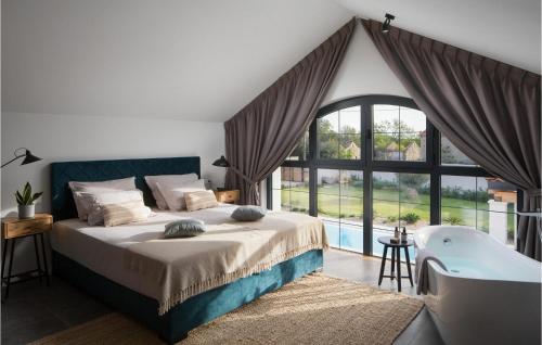 ein Schlafzimmer mit einem Bett, einer Badewanne und einem großen Fenster in der Unterkunft Villa Manana in Gornji Zemunik