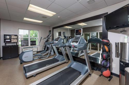 a gym with cardio machines and a flat screen tv at Homewood Suites by Hilton Portland in Scarborough