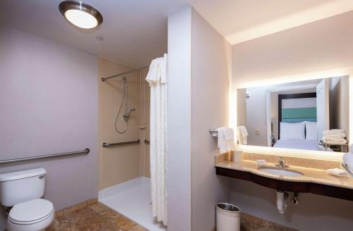 a bathroom with a toilet and a shower and a sink at Homewood Suites by Hilton Portland in Scarborough