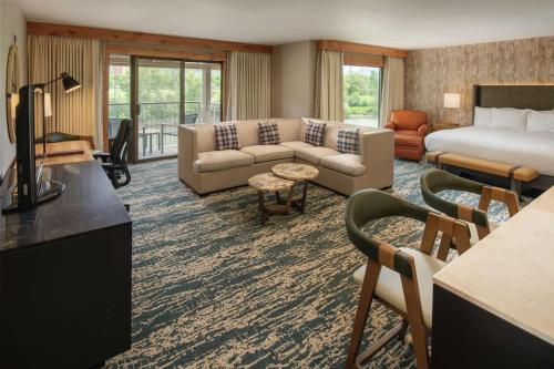 a hotel room with a bed and a living room at DoubleTree by Hilton Missoula Edgewater in Missoula
