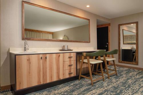 a bathroom with a sink and a mirror at DoubleTree by Hilton Missoula Edgewater in Missoula