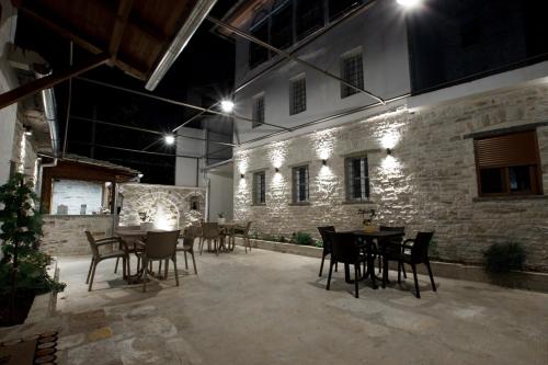 a patio with tables and chairs at night at Guesthouse Çani in Gjirokastër