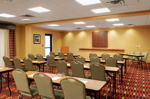 a conference room with tables and chairs and a podium at Hampton Inn & Suites Baton Rouge - I-10 East in Baton Rouge