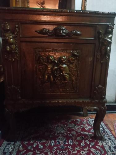 a wooden cabinet with a carving of two people on it at ElSultan Hotel in Cairo