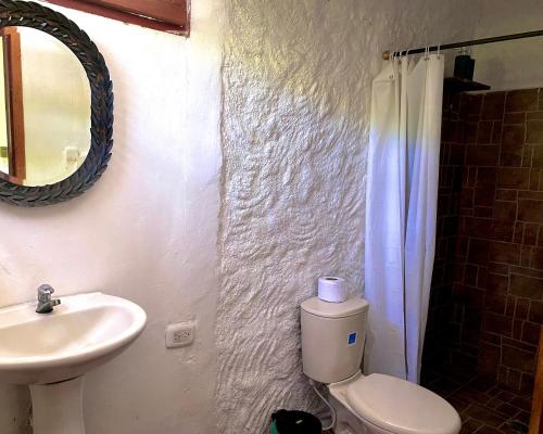 a bathroom with a sink and a toilet and a mirror at Minca Santa Marta Casa Scalea in Minca