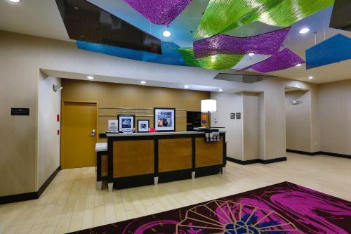 a lobby with a reception desk and purple lights at Hampton Inn and Suites Missouri City in Missouri City