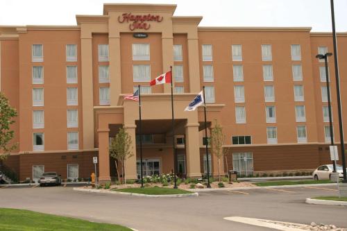 a hotel building with flags in front of it at Hampton Inn by Hilton North Bay in North Bay