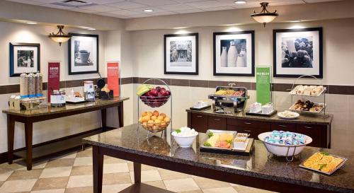 a buffet line with fruits and baskets of food at Hampton Inn by Hilton North Bay in North Bay