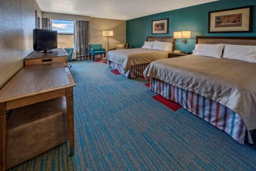 a hotel room with two beds and a flat screen tv at Hampton Inn Kayenta Monument Valley in Kayenta