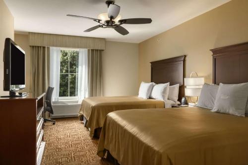 a hotel room with two beds and a ceiling fan at Homewood Suites by Hilton Binghamton/Vestal in Vestal