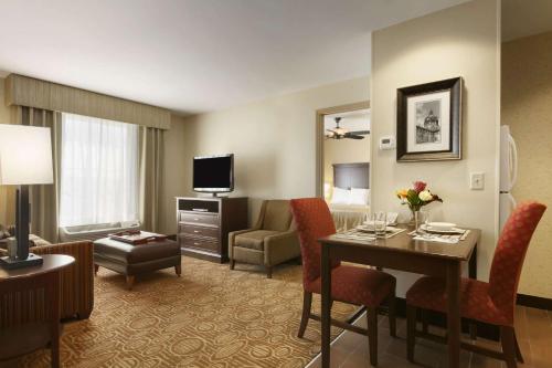 a hotel room with a desk and a living room at Homewood Suites by Hilton Binghamton/Vestal in Vestal