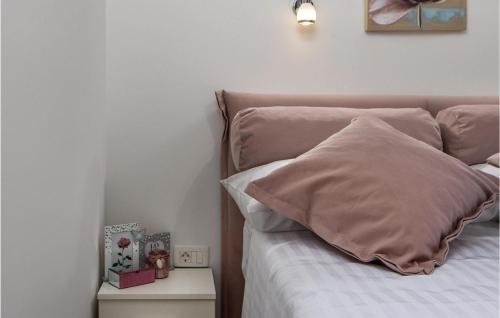 a bed with a pink pillow on top of it at Villa Ivandvor in Sinj