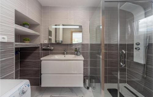 een badkamer met een wastafel en een glazen douche bij Villa Ivandvor in Sinj