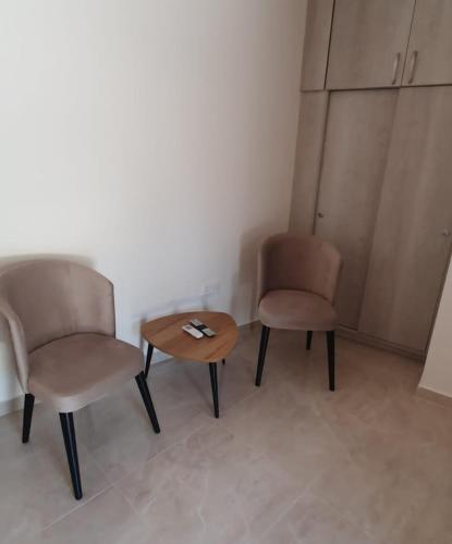 2 Stühle und ein Tisch in einem Zimmer in der Unterkunft Village Gem Peledri Studio in Pelendri