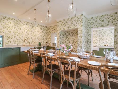 a dining room with a wooden table and chairs at Syleham House in Eye