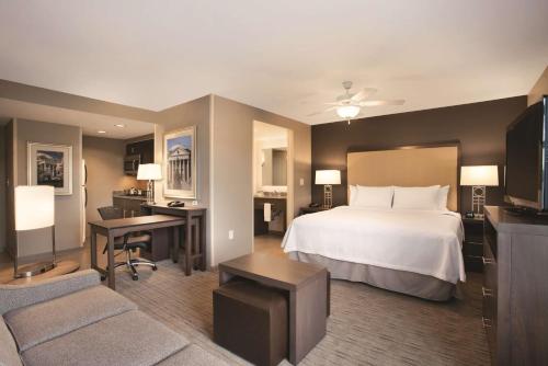 a hotel room with a bed and a desk at Homewood Suites by Hilton - Charlottesville in Charlottesville