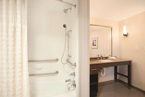 a bathroom with a shower and a sink at Homewood Suites by Hilton - Charlottesville in Charlottesville