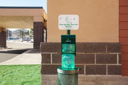 a sign on top of a trash can next to a building at Home2 Suites by Hilton Denver West / Federal Center in Lakewood