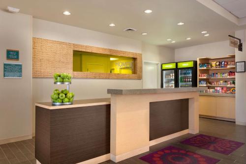 a lobby with a counter with apples on it at Home2 Suites by Hilton Denver West / Federal Center in Lakewood